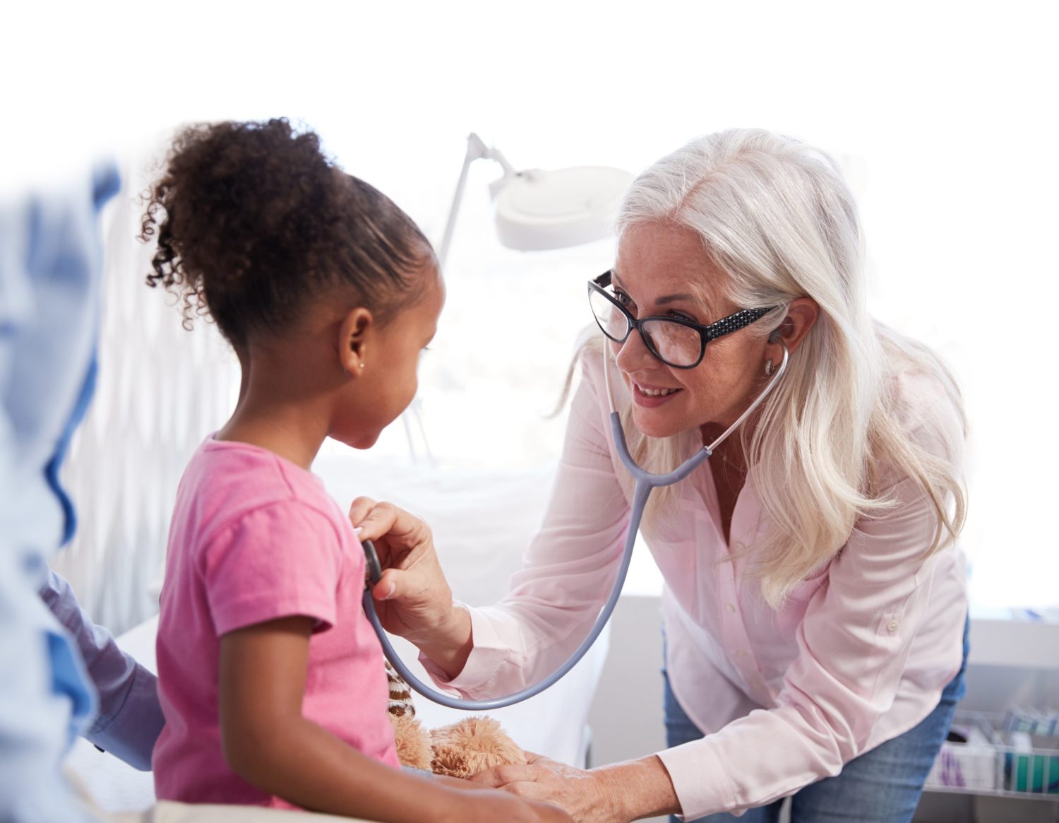Father,With,Daughter,In,Consultation,With,Doctor,In,Office